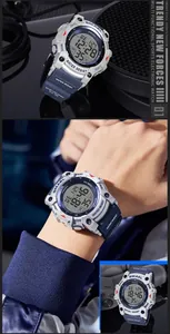 Close-up of SMAEL waterproof digital sports watch with rugged grey and blue design.