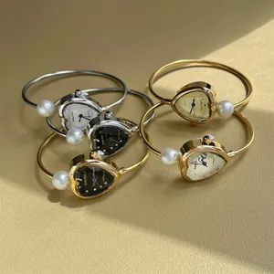 SUNLIFEX heart-shaped gold and silver bangle watches with pearl detail and quartz movement