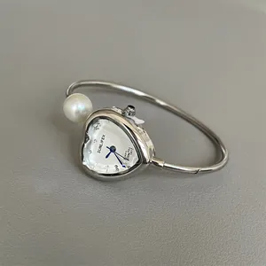 Exquisite silver heart-shaped bracelet watch for women featuring a pearl detail