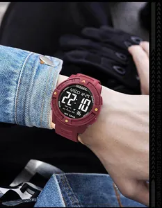 Detailed close-up of a burgundy Smael men's digital sports watch worn on a wrist.
