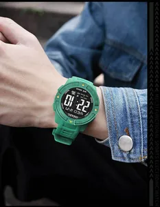 Close-up of green SMAEL men's digital sports watch with LED display and rubber strap