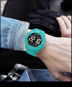 Close-up detail of the SMAEL men's digital sports watch featuring a turquoise resin strap.
