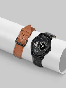 Primo piano dell'orologio al quarzo TOMI da uomo con cinturini in pelle nera e marrone