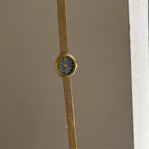 Elegant gold mesh strap quartz fashion watch featuring a classic dark blue dial and bezel