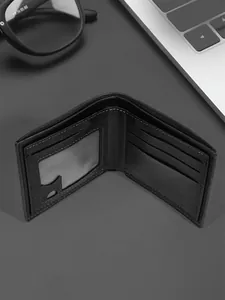 Detailed view of black bi-fold leather wallet with internal card slots and ID window