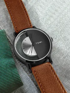 Close-up of TOMI men's watch with brown leather strap and unique dual-tone dial