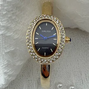Elegante Vintage-Armreif-Uhr für Damen mit goldener Diamant-Lünette und schwarzem Zifferblatt.
