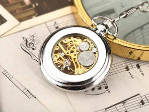 Close-up of mechanical watch movement showing intricate golden gears on music sheets