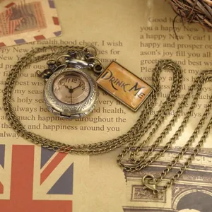 Vintage bronze pocket watch necklace with Drink Me tag and ornate engraved design.