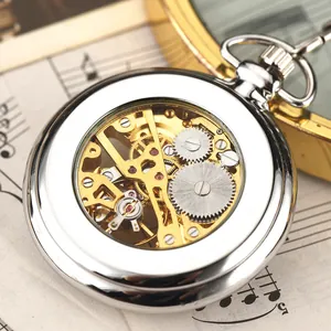 Detailed macro view of a silver mechanical pocket watch with visible golden gears