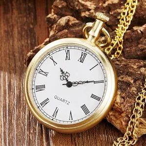 Detailed close-up of vintage gold pocket watch with Roman numerals on a wood surface