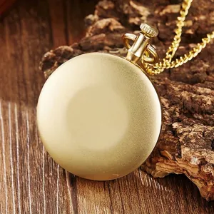Detailed back view of a vintage gold-toned pocket watch resting on rustic wood bark background