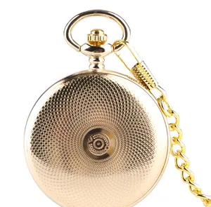 Detailed macro view of the back cover of a vintage gold mechanical pocket watch with pattern