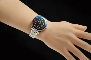 Close-up of WINNER automatic mechanical watch with red and blue bezel on wrist