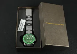 Detailed view of silver automatic mechanical watch with green dial inside brown gift box