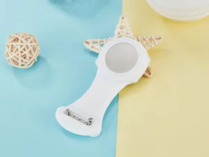 Back view of a white silicone nurse watch showing the safety pin and metal back