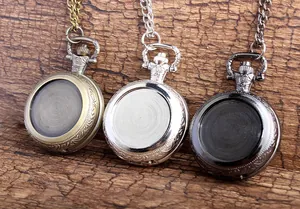 Detailed view of vintage DIY pocket watch necklaces in three colors on wood.