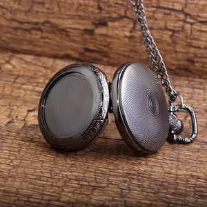 Macro view of an open antique style black pocket watch with a blank DIY photo area