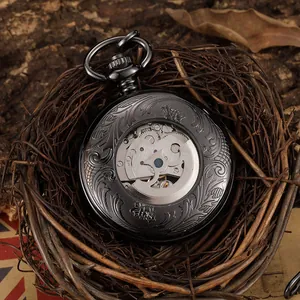 Vintage black mechanical pocket watch with hollow floral engravings in a bird's nest.