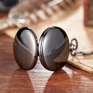 Detail view of a vintage double-sided polished black chrome mechanical pocket watch