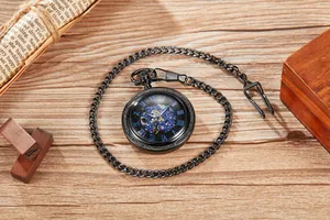 Vintage mechanical pocket watch with blue skeleton dial and Roman numerals on wood