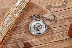 Macro detail of a vintage silver skeleton mechanical pocket watch with Roman numerals