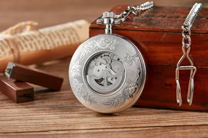 Detailed view of the skeleton mechanical movement and floral engraving on the pocket watch