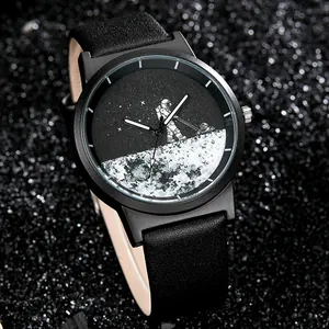 Close-up detail of astronaut mowing the moon dial on a black minimalist quartz watch