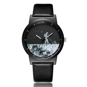 Detail view of black quartz watch featuring an astronaut mowing the moon on dial