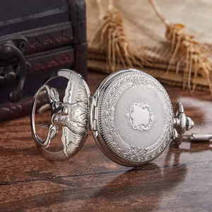 Detail view of a silver vintage mechanical pocket watch featuring a hollow deer design