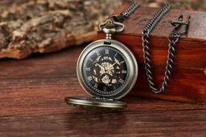 Detailed view of a vintage skeleton mechanical pocket watch on a rustic wooden background