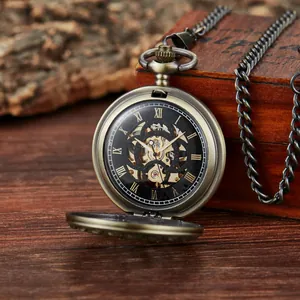 Vintage mechanical pocket watch with carved hollow floral pattern and bronze chain