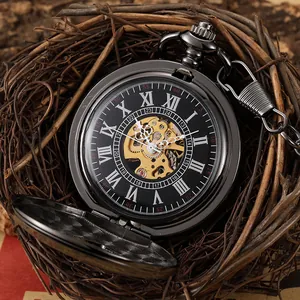 Close-up of retro black skeleton mechanical pocket watch with gold gear mechanism