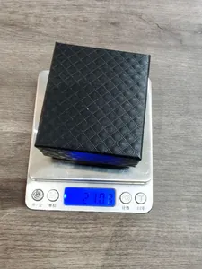 Imagen detallada de la caja de joyas negra que pesa 21,03 g en una báscula digital.