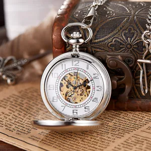 Detailed view of a vintage silver mechanical pocket watch with an intricate skeleton dial