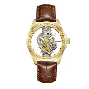 Detailed macro view of men's skeleton watch with gold case and brown leather strap.