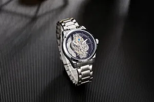 Close-up of a silver men's watch featuring a sophisticated double-sided skeleton dial design