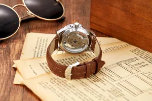 Detailed macro view of men's luxury skeleton automatic watch with brown leather strap