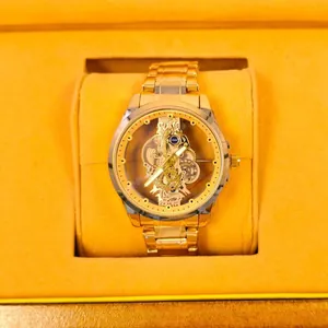 Luxurious men's gold skeleton automatic watch with a transparent mechanical gear dial