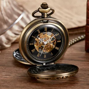 Close-up detail view of a vintage bronze double-open engraved mechanical pocket watch