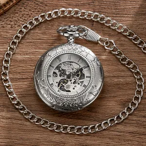 Detailed macro view of the vintage skeleton pocket watch with intricate floral engravings.