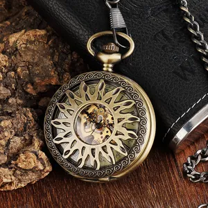 Detail view of a vintage bronze mechanical pocket watch with hollow sun-carved flip cover