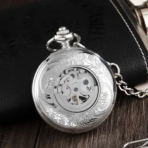 Close-up detail of silver vintage mechanical pocket watch with floral engraving