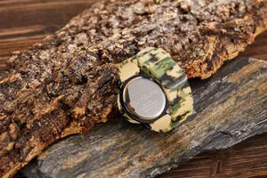 Close-up of camouflage sport watch back showing stainless steel case and silicone strap