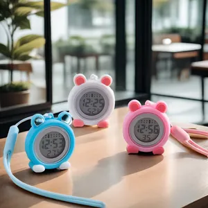 Close-up of three colorful cartoon silicone digital nurse watches on a wooden table