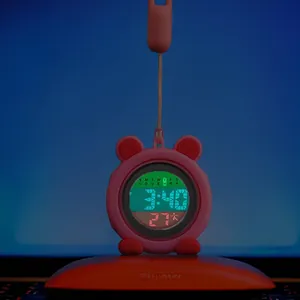 Close-up of a pink luminous cartoon silicone nurse watch with glowing digital display