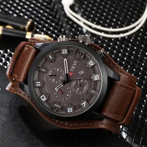 Close-up of KTEVI men's sports watch with brown leather strap and multi-function dial