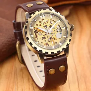 Macro view of the bronze gear bezel and golden skeleton dial on an automatic watch
