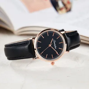 Macro detail view of the minimalist watch face with black dial and rose gold indices