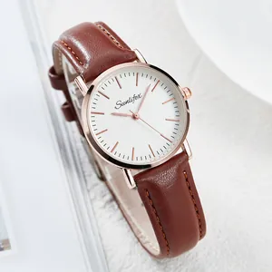 Close-up of elegant minimalist quartz watch with brown leather strap and white dial
